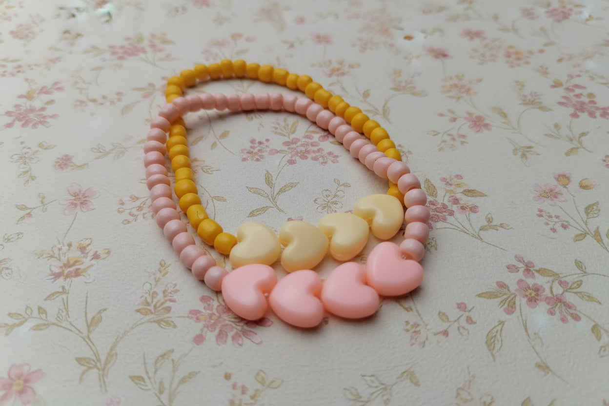 pink and yellow heart bracelets
